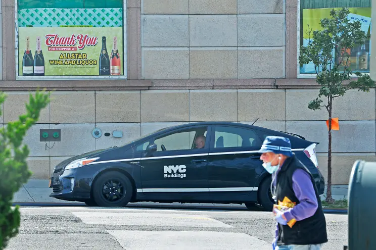 Building inspector wearing a hard hat and safety vest, focusing on site safety and regulations.